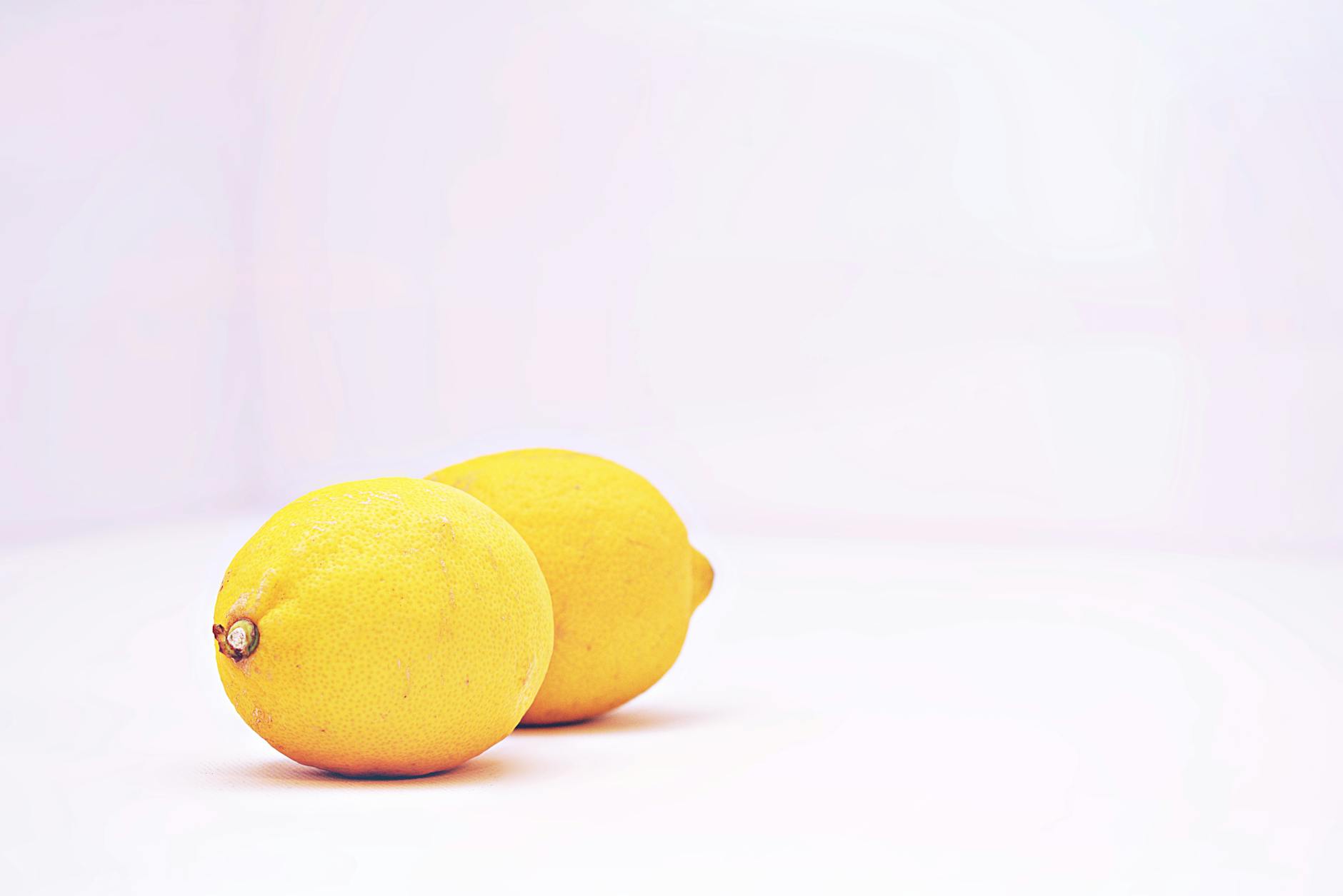 Fresh lemons on a clean white background, symbolizing a new beginning