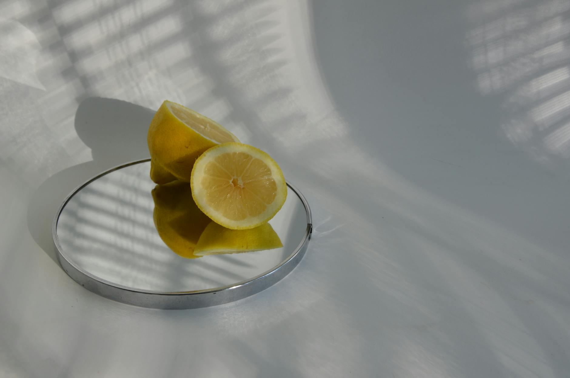 A teal lemon vibrator on smooth white silk fabric, symbolizing luxury and reconnection