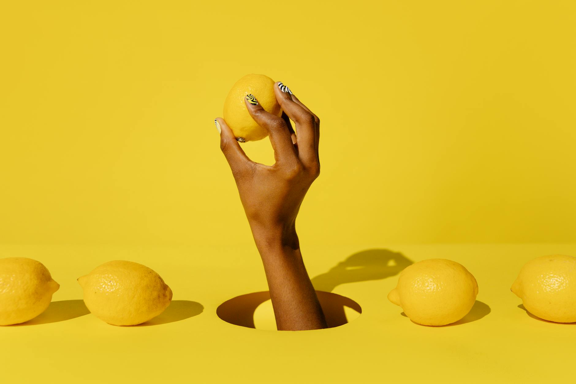 Yellow silicone vibrator surrounded by fresh fruit on a bright surface, representing returning to pleasure