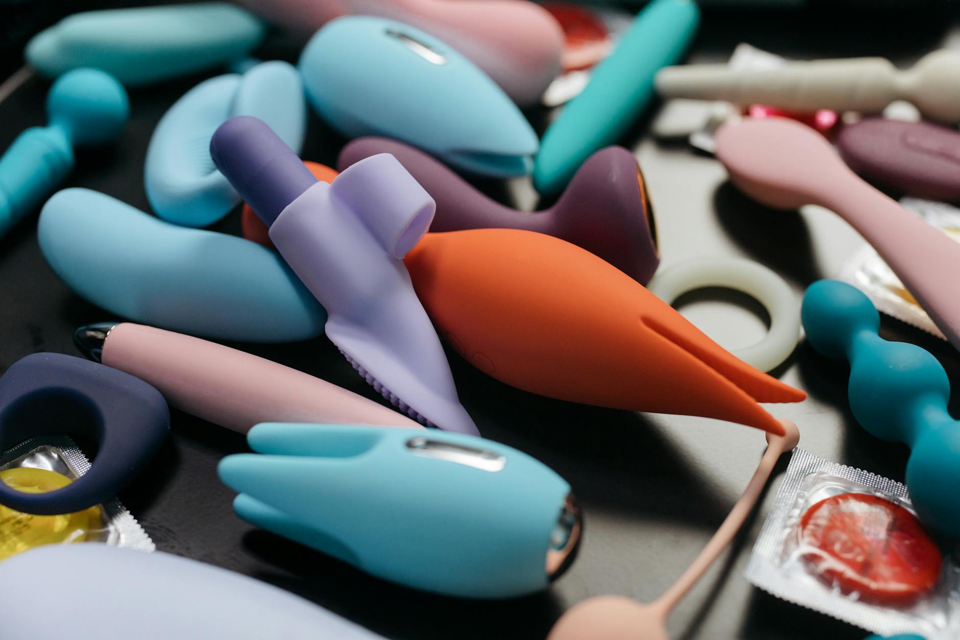 An array of vibrant adult toys including lemon clitoral vibrators and other options in close-up view